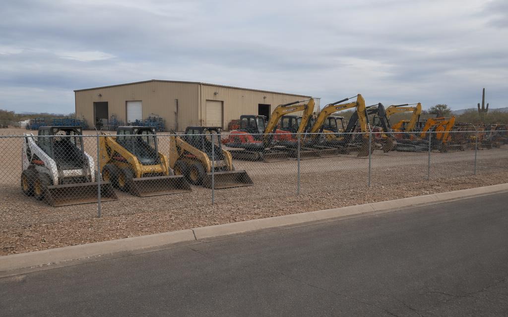 Street imagery at the registered address. Fenced commercial lot with machines on the ground, matching the commercial delivery-point classification and the yard described on the filing.